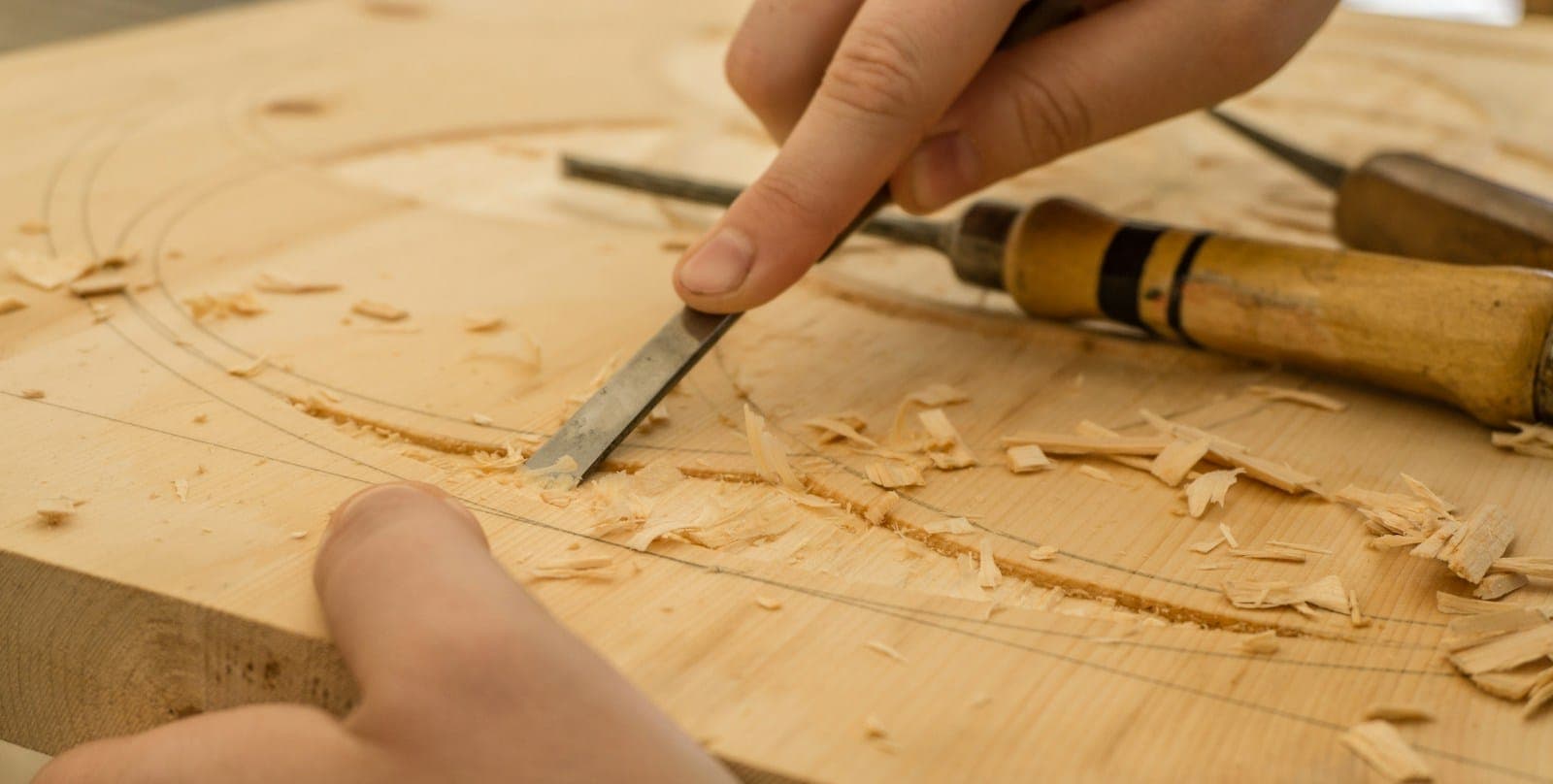 Hand chisel shaping a piece of wood
