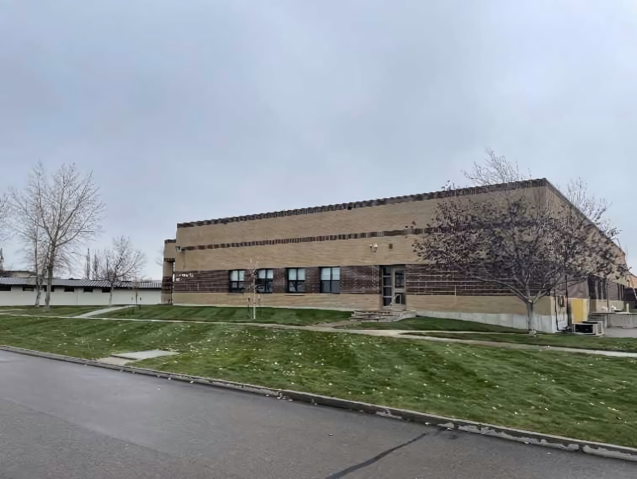 Exterior of the Montana Air National Guard flight command facility, a tan brick building with a landscaped lawn