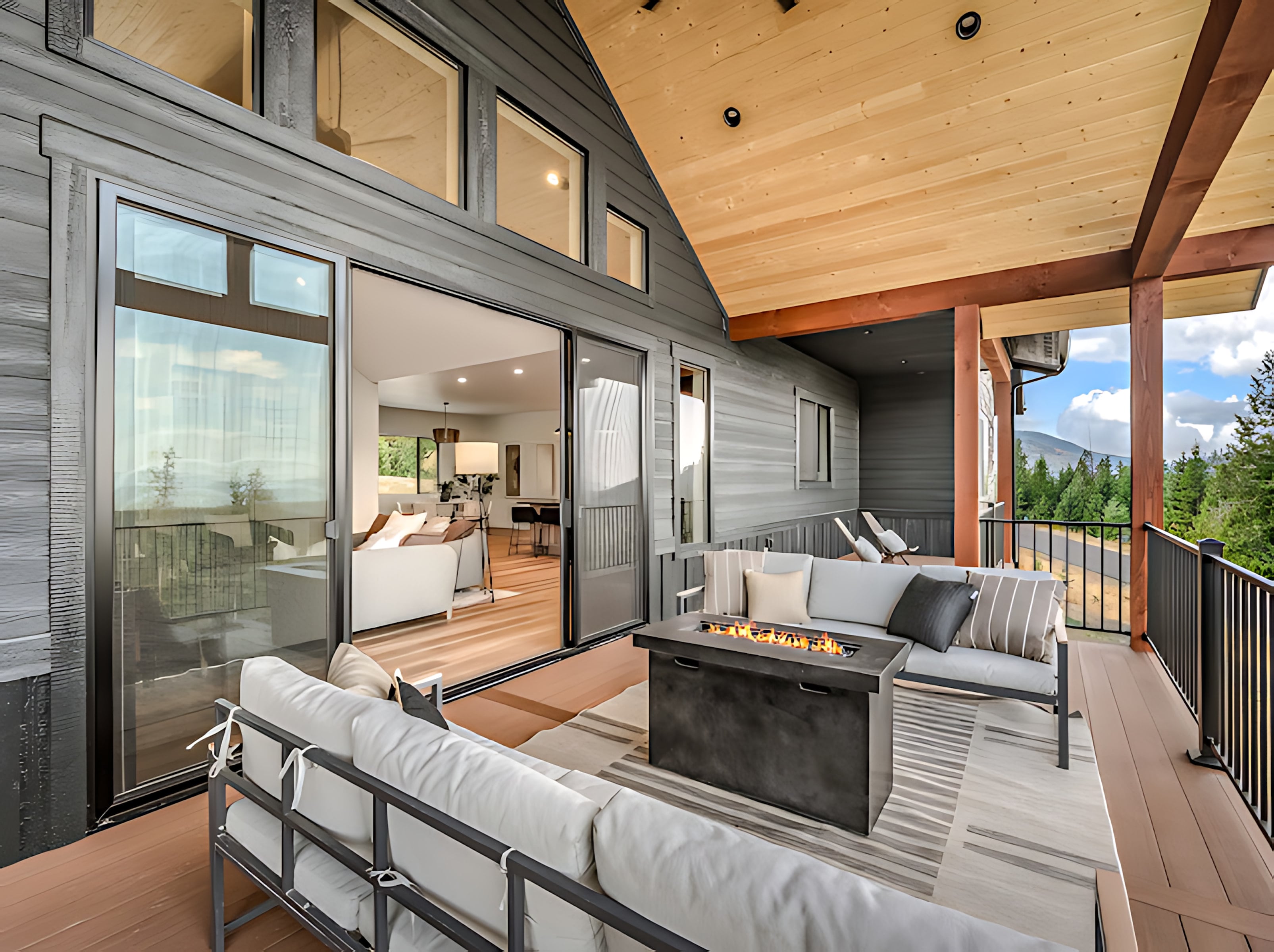 Covered outdoor living deck with sliding glass doors opening to the great room