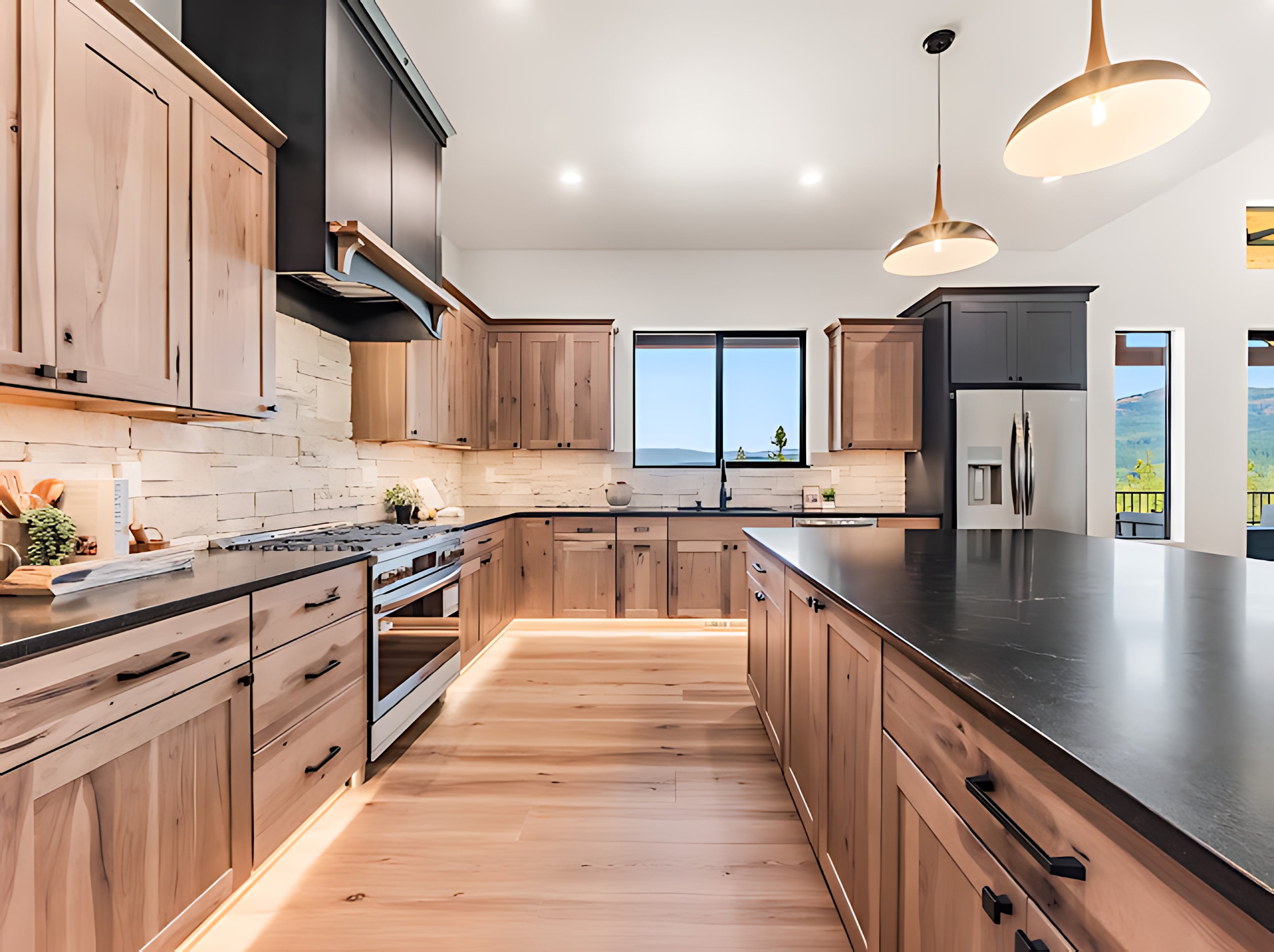 Rustic wood kitchen cabinetry with dark stone countertops and a stainless gas range
