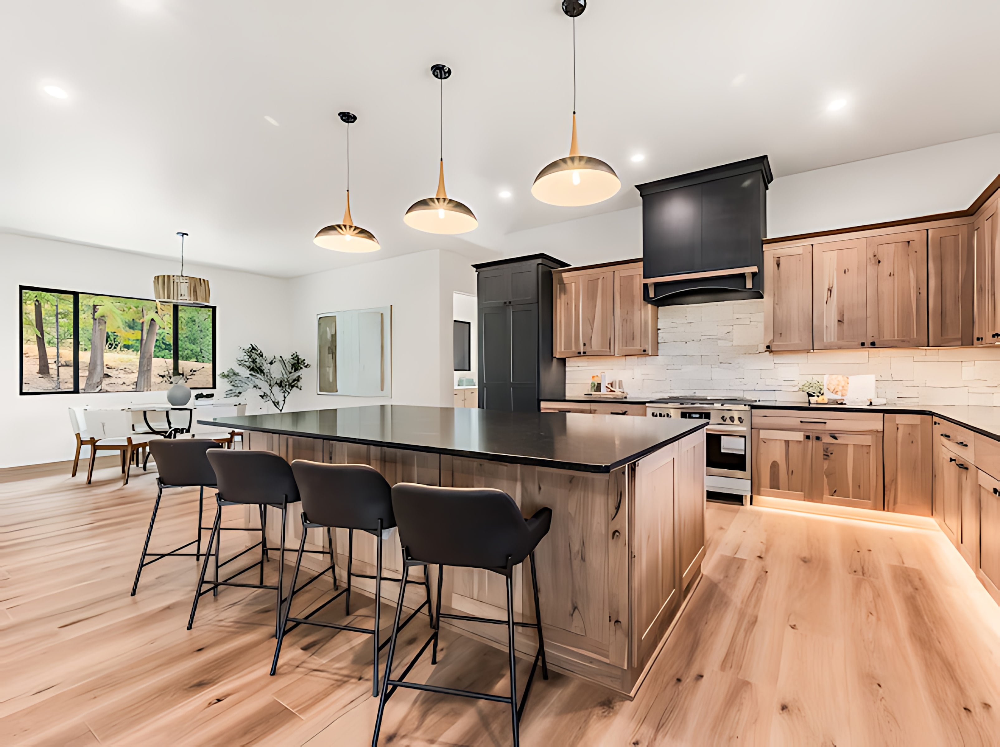 Kitchen island with bar seating opening to a bright dining area